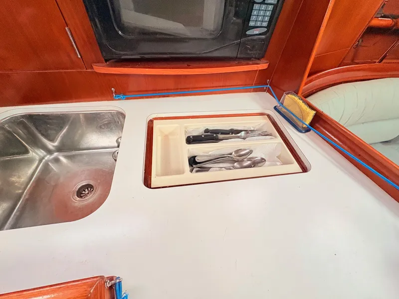 Slide: The Image of The galley of a 2005 Beneteau Oceanis Clipper 343 features a sink and cutlery drawer. - 29
