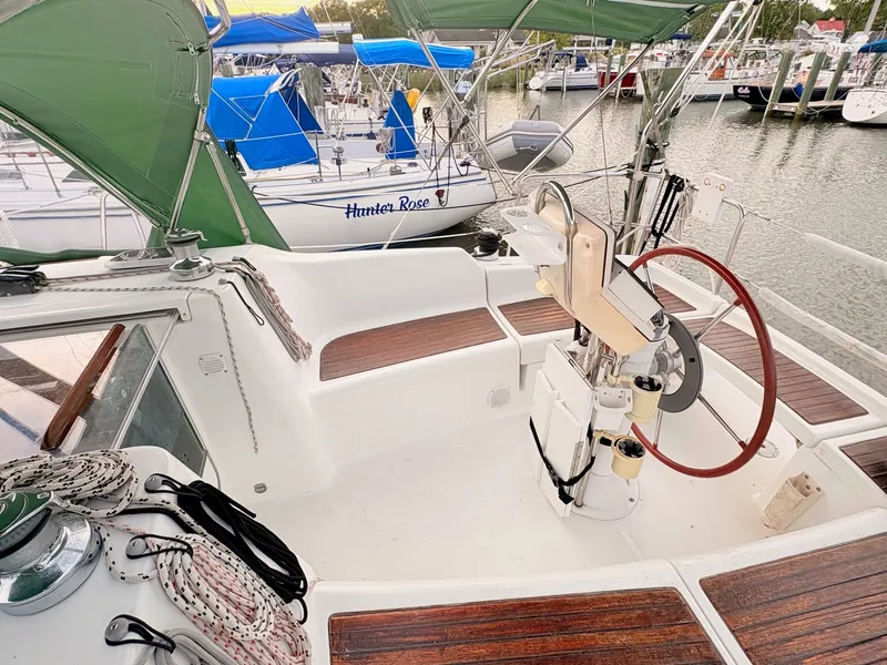 Slide: The Image of The cockpit of a 2005 Beneteau Oceanis Clipper 343 with wood accents and green sunshade. - 15