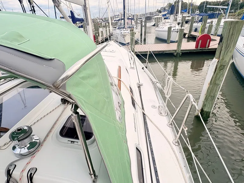 Slide: The Image of The 2005 Beneteau Oceanis Clipper 343 is docked, featuring a green canopy. - 8