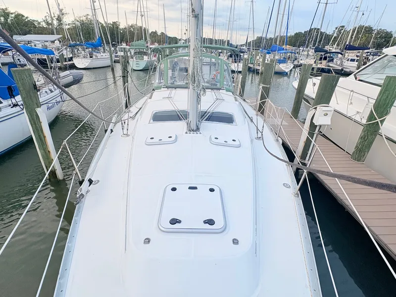 Slide: The Image of The image shows the deck of a 2005 Beneteau Oceanis Clipper 343 in a marina. - 12