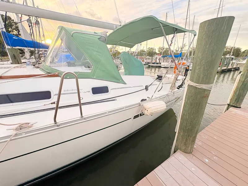 Slide: The Image of A 2005 Beneteau Oceanis Clipper 343 docked at a wooden pier in a marina. - 45