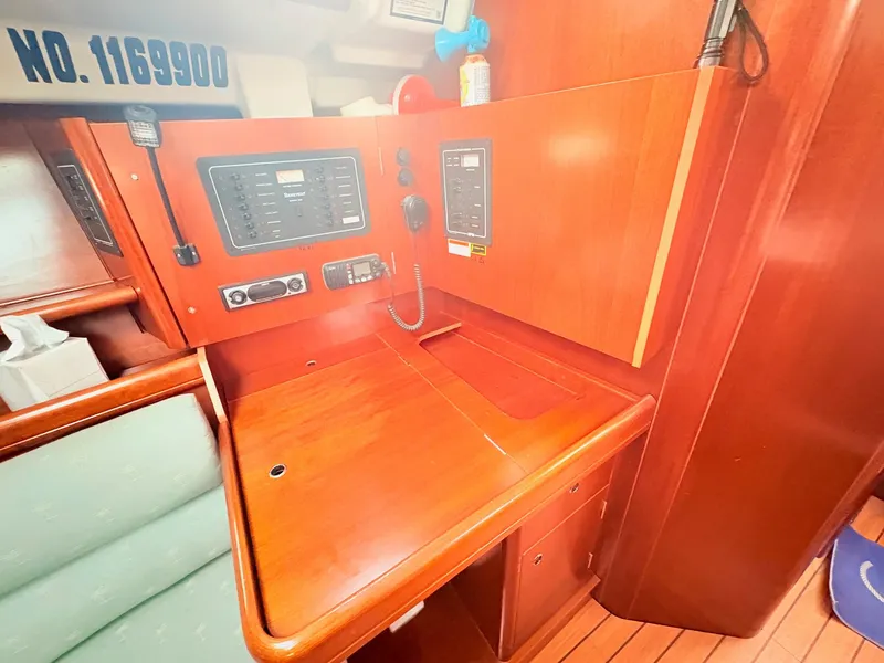 Slide: The Image of The interior of a 2005 Beneteau Oceanis Clipper 343 features a wooden table with navigation instruments. - 24