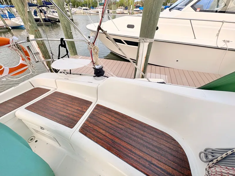 Slide: The Image of The cockpit of a 2005 Beneteau Oceanis Clipper 343 with wooden flooring and surrounding boats. - 43