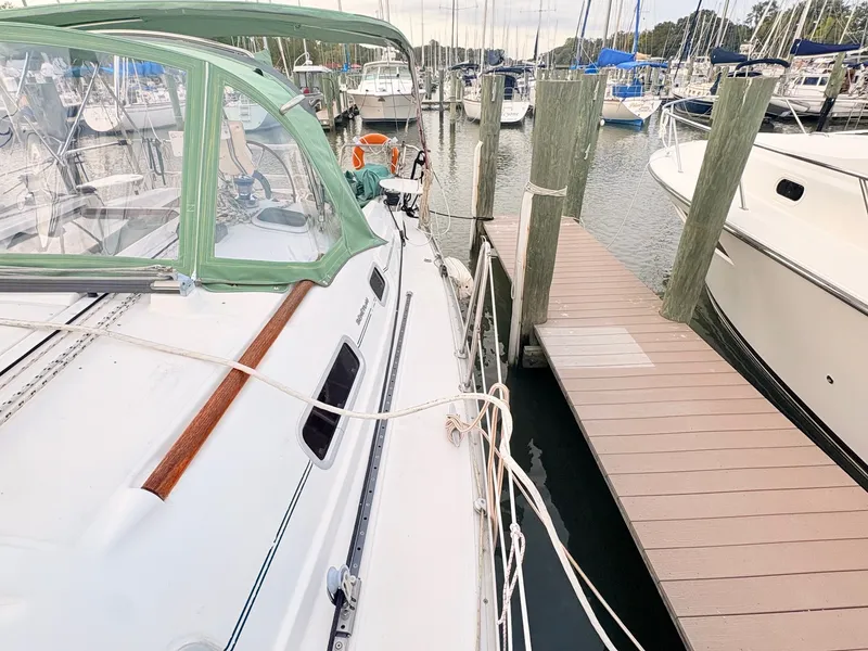 Slide: The Image of A 2005 Beneteau Oceanis Clipper 343 docked at a wooden pier in a marina. - 14