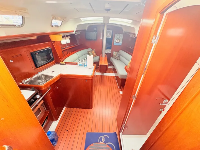 Slide: The Image of Interior of a 2005 Beneteau Oceanis Clipper 343 with wooden floors and cozy seating areas. - 20
