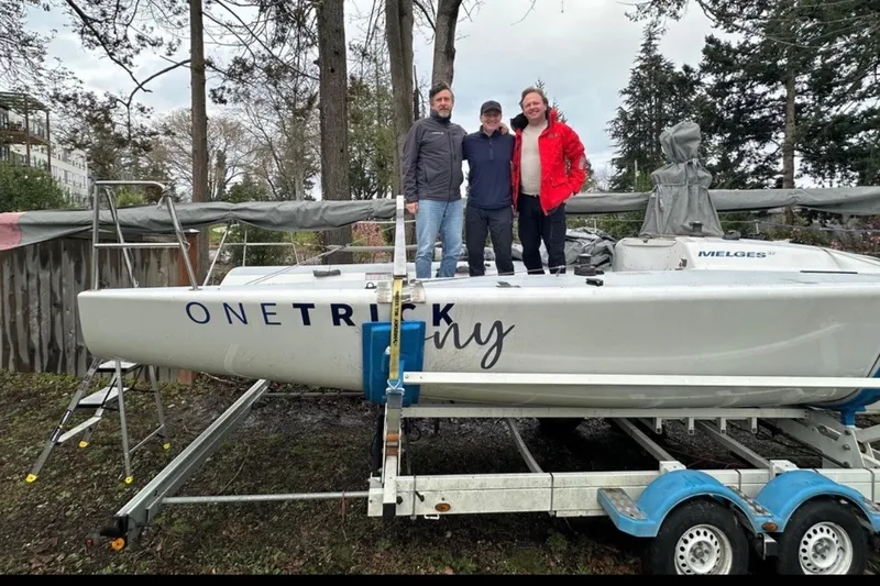Slide: The Image of Three people standing on a 2008 Melges 32 sailboat named "One Trick Pony." - 12
