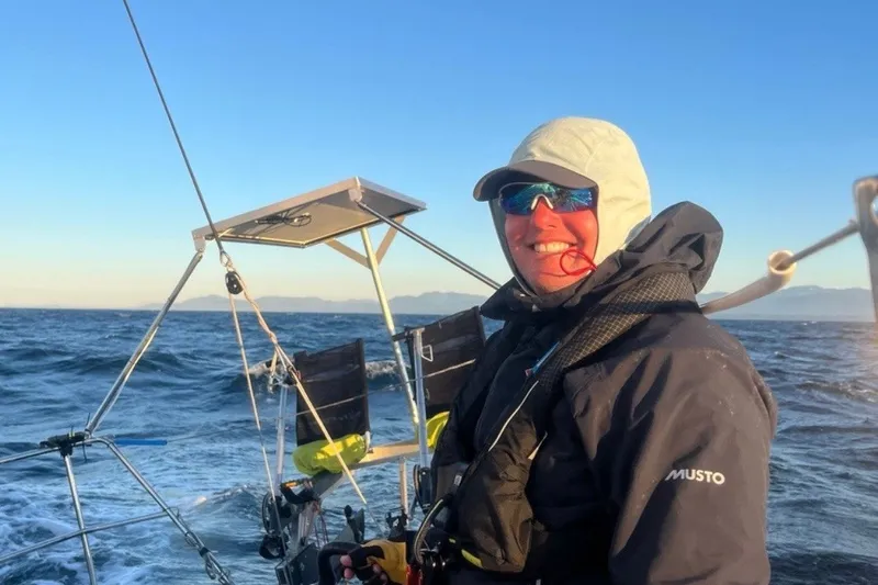 Slide: The Image of Person sailing on a 2008 Melges 32 boat, wearing protective gear, with ocean backdrop. - 18