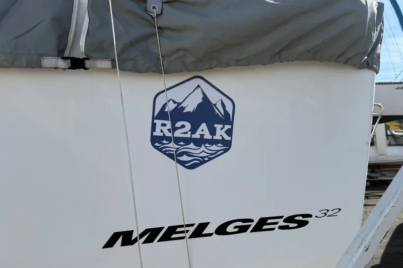 Slide: The Image of Melges 32 sailboat with R2AK logo, 2008 model, partially covered. - 14