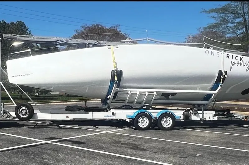 Slide: The Image of 2008 Melges 32 sailboat on trailer in parking lot, ready for transport. - 1