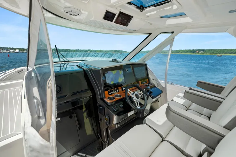 Slide: The Image of 2022 Tiara Yachts 38 LS helm with modern navigation system and luxurious seating. - 18