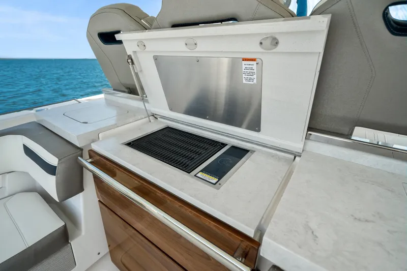 Slide: The Image of Outdoor kitchen on 2022 Tiara Yachts 38 LS, featuring a grill and storage. - 25