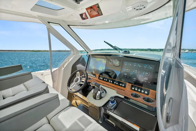 Slide: The Image of Luxurious 2022 Tiara Yachts 38 LS helm with advanced navigation displays and plush seating. - 17
