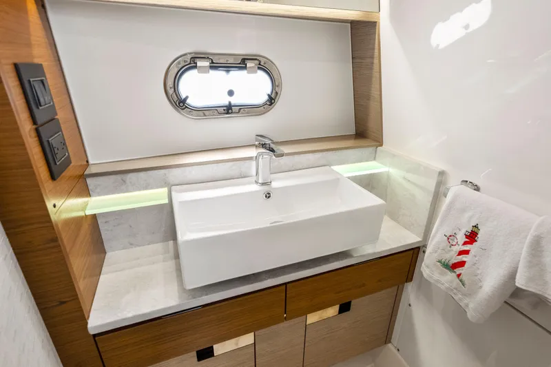 Slide: The Image of Luxurious bathroom interior of 2022 Tiara Yachts 38 LS with modern sink and nautical decor. - 30