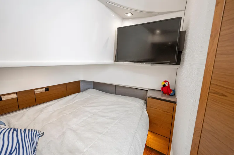 Slide: The Image of Interior cabin of 2022 Tiara Yachts 38 LS with bed, TV, and parrot plush. - 28
