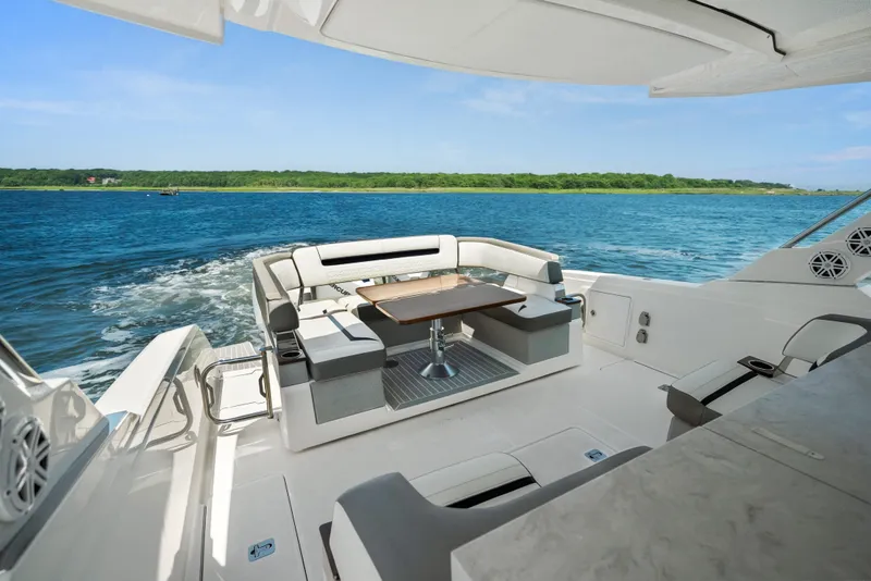Slide: The Image of Luxurious 2022 Tiara Yachts 38 LS with elegant seating, cruising on serene blue waters. - 20