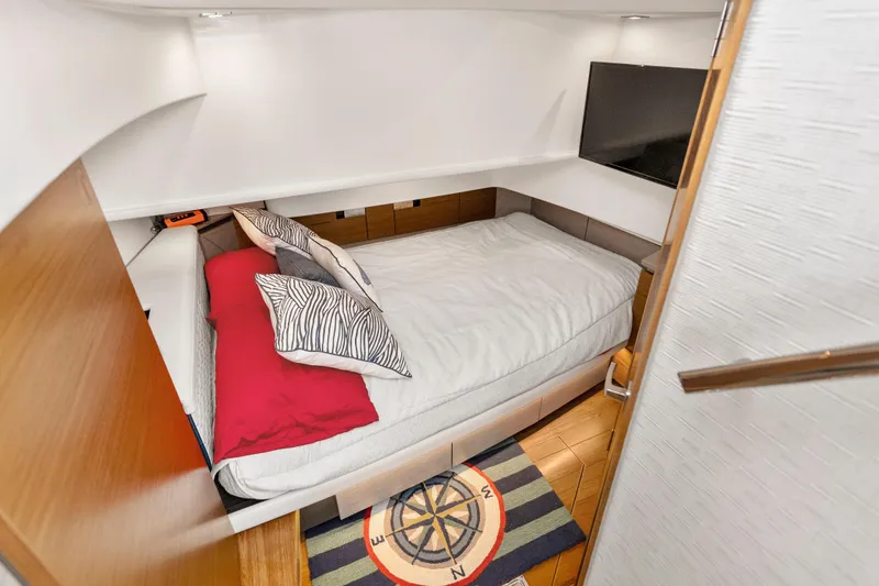 Slide: The Image of Luxurious cabin interior of 2022 Tiara Yachts 38 LS with cozy bed and modern decor. - 27