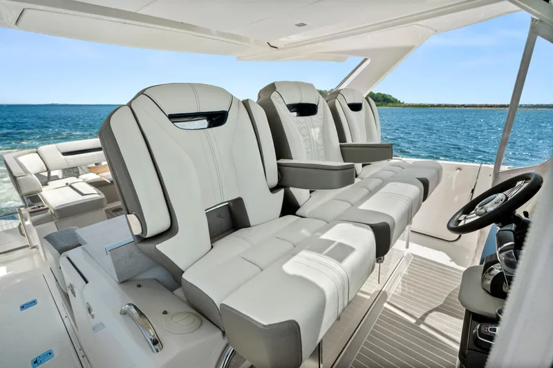 Slide: The Image of Luxurious seating on 2022 Tiara Yachts 38 LS, overlooking serene ocean waters. - 19