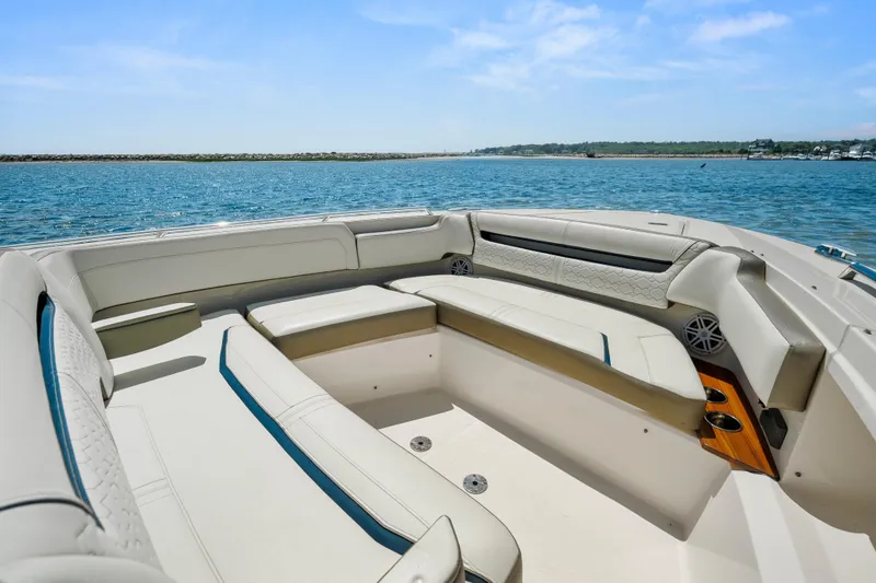 Slide: The Image of Luxurious seating area on 2022 Tiara Yachts 38 LS, overlooking serene ocean waters. - 31