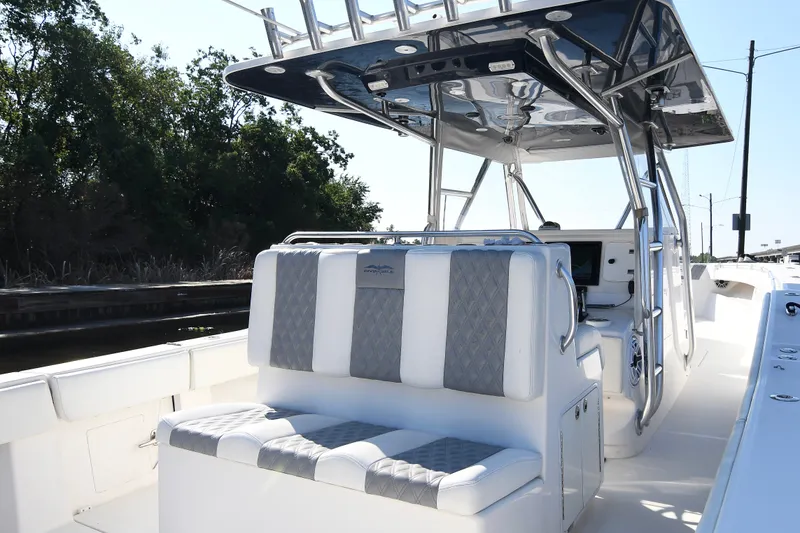 Slide: The Image of 2014 Invincible 42 Open Fisherman boat interior with cushioned seating and sleek design. - 16