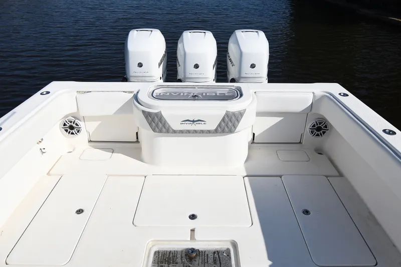 Slide: The Image of 2014 Invincible 42 Open Fisherman boat with triple outboard engines on calm water. - 19