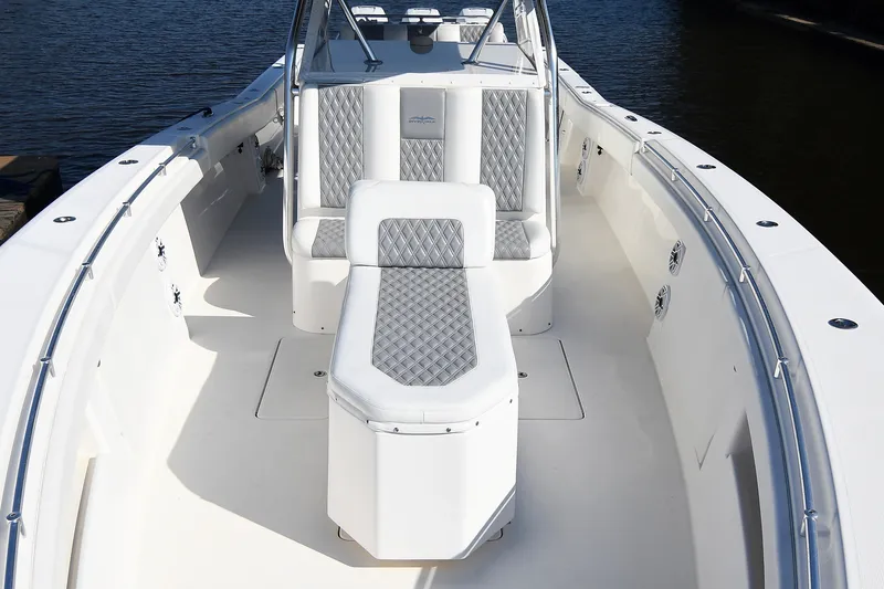 Slide: The Image of 2014 Invincible 42 Open Fisherman boat interior with cushioned seating and sleek design. - 20