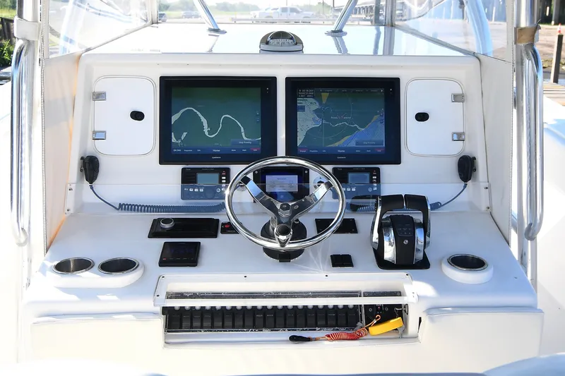Slide: The Image of Console of 2014 Invincible 42 Open Fisherman with navigation screens and controls. - 17