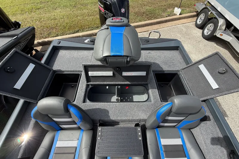 Slide: The Image of 2027 Ranger RT188P boat interior with open storage compartments and blue-accented seats. - 13