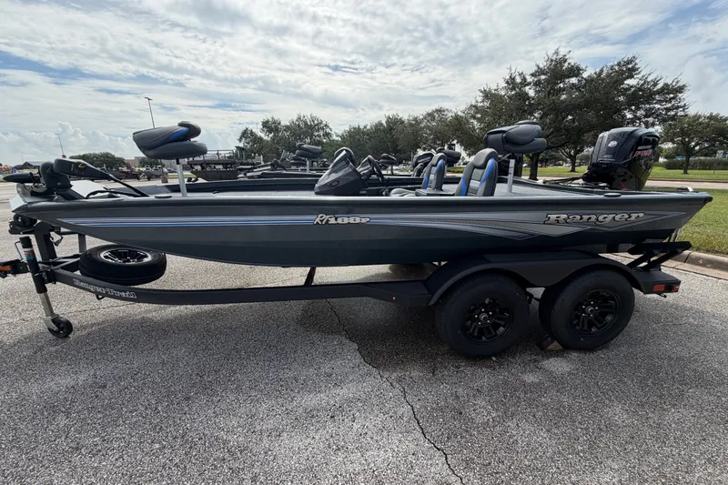 Slide: The Image of 2027 Ranger RT188P fishing boat on trailer, parked outdoors under cloudy sky. - 108