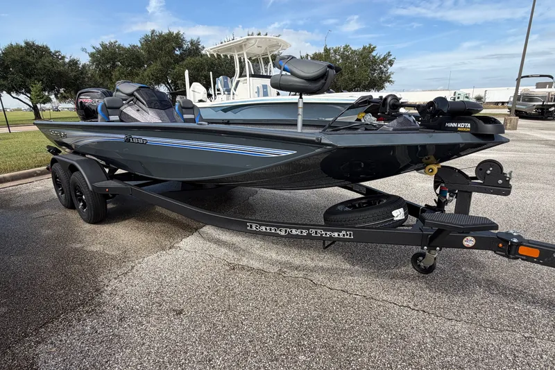 Slide: The Image of 2027 Ranger RT188P boat on trailer in parking lot, clear sky background. - 112