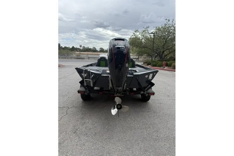 Slide: The Image of 2027 Ranger RT188P boat rear view with outboard motor on a trailer. - 2