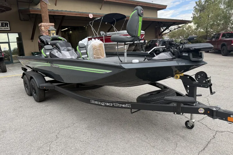 Slide: The Image of 2027 Ranger RT188P fishing boat on trailer, parked outside a building. - 3