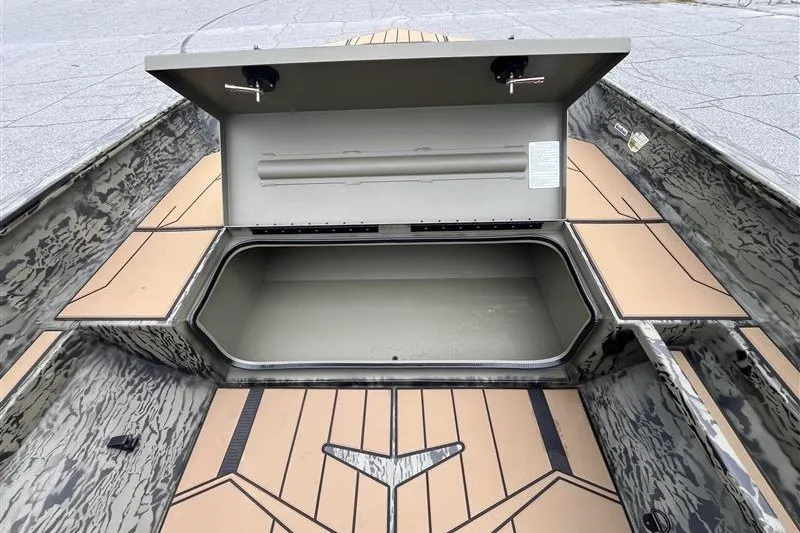 Slide: The Image of Open storage compartment of 2027 Tracker Grizzly 1553 Timber boat, showcasing interior space. - 13