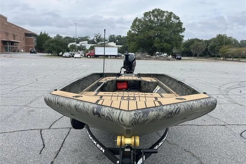 Slide: The Image of 2027 Tracker Grizzly 1553 Timber boat on trailer in parking lot. - 15