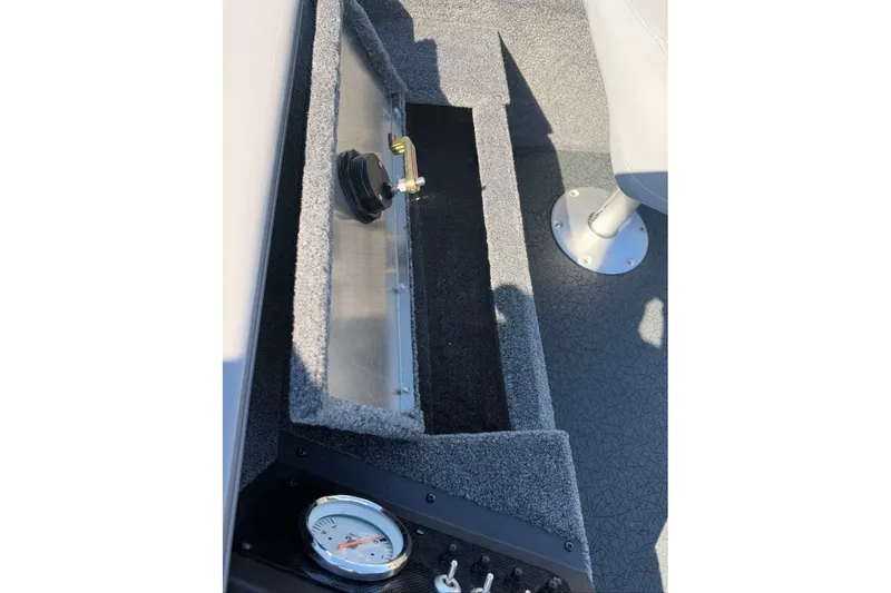 Slide: The Image of Interior of 2027 Tracker Super Guide V-16 T boat showing storage compartment and gauge. - 15