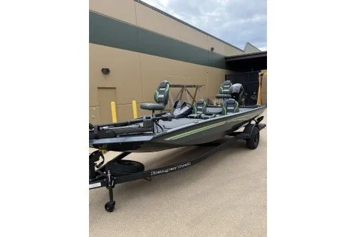The Image of 2027 Ranger RT188P fishing boat on trailer, parked outdoors near a building. - 0