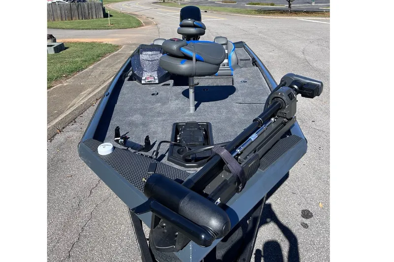 Slide: The Image of 2027 Ranger RT178 fishing boat with trolling motor and seating on a paved surface. - 3