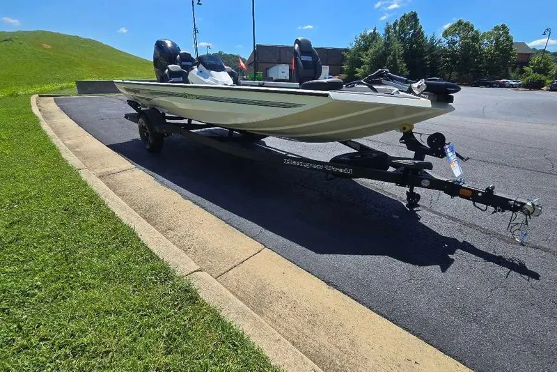 The Image of 2027 Ranger RT188 boat on trailer in sunny parking lot. - 0