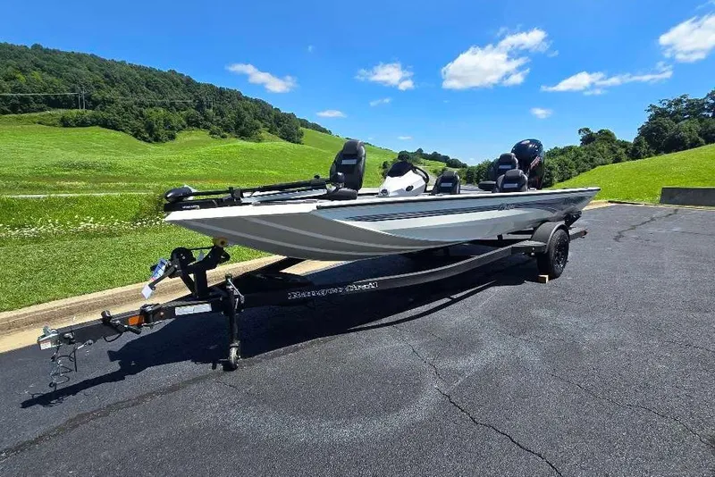 Slide: The Image of 2027 Ranger RT188 boat on trailer, parked on asphalt with scenic green hills. - 10