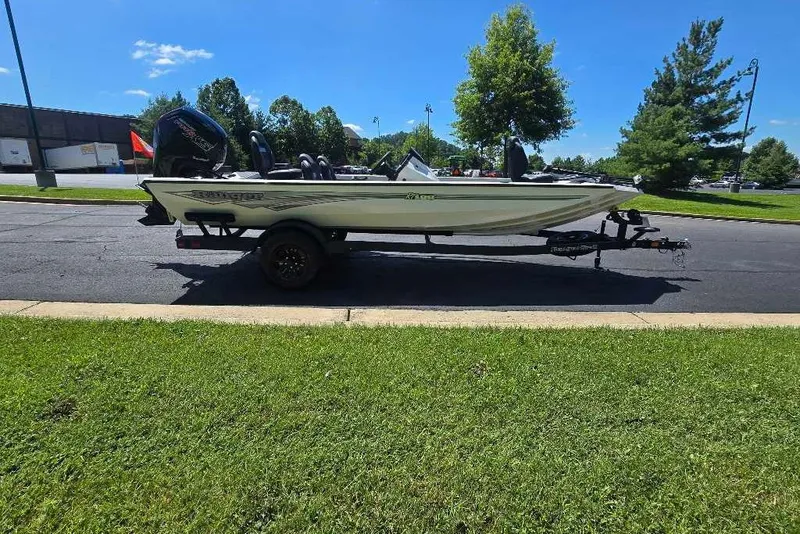 Slide: The Image of 2027 Ranger RT188 boat on trailer, parked on asphalt near green grass and trees. - 11