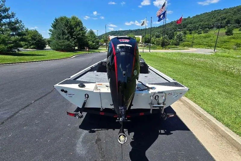 Slide: The Image of 2027 Ranger RT188 boat on trailer, parked on a sunny day with flags in the background. - 4