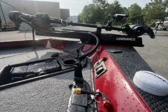 Slide: The Image of 2027 Ranger RT178 boat deck with Lowrance equipment, wet surface, and outdoor setting. - 5