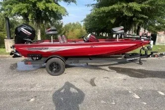Slide: The Image of Red 2027 Ranger RT178 boat on trailer, parked outdoors with trees in background. - 3