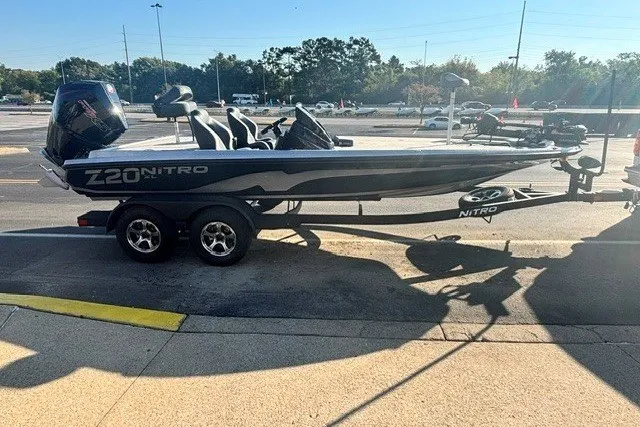 Slide: The Image of 2027 Nitro Z20 XL Pro boat on trailer, parked outdoors in sunny setting. - 2