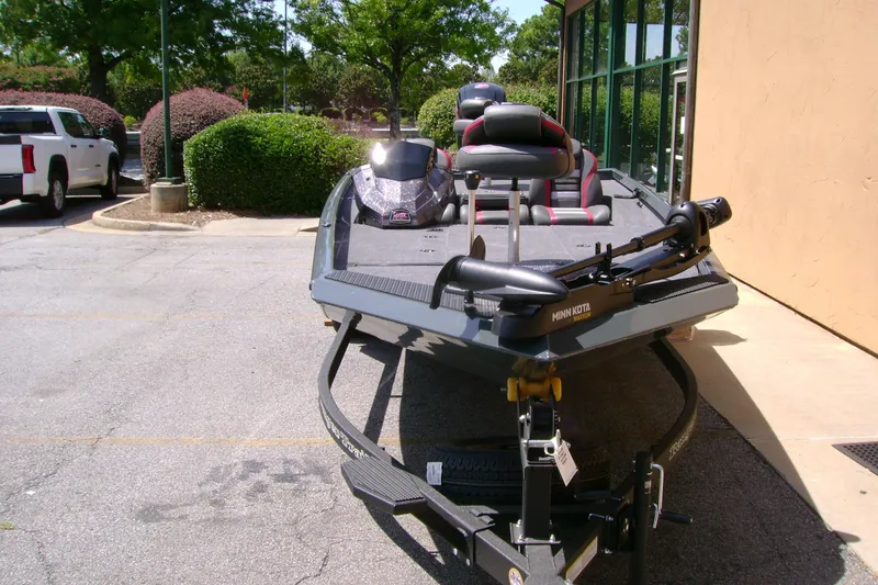 Slide: The Image of 2027 Ranger RT188P boat with Minn Kota trolling motor in a parking lot. - 2