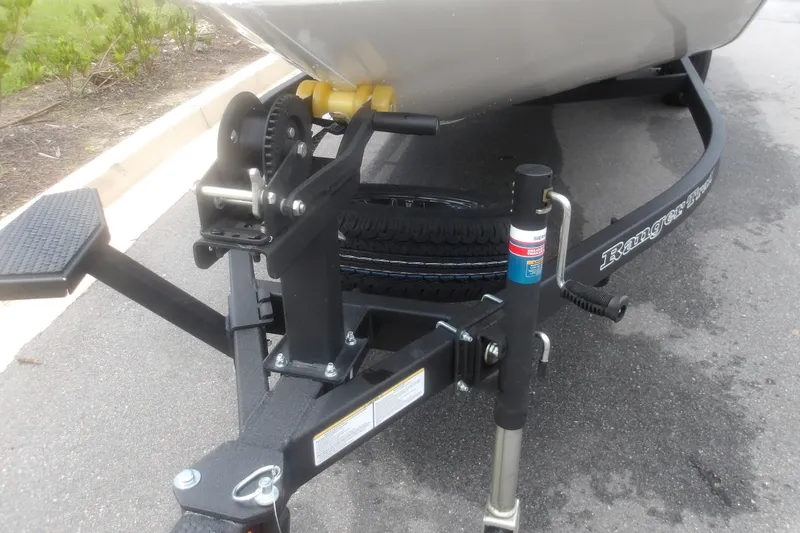 Slide: The Image of Trailer hitch and winch of a 2027 Ranger RT198P boat on pavement. - 12