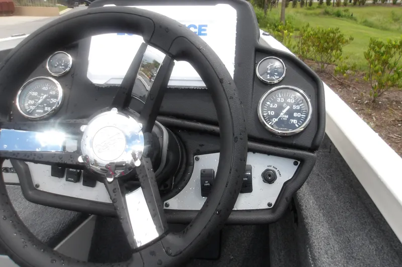 Slide: The Image of Steering wheel and dashboard of 2027 Ranger RT198P boat with gauges and controls. - 16