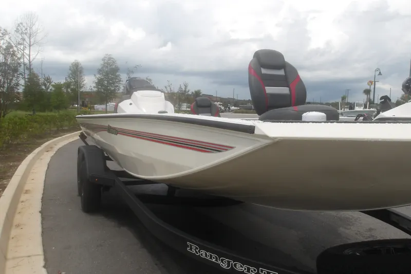 Slide: The Image of 2027 Ranger RT198P boat on trailer, parked on a road with cloudy sky. - 4