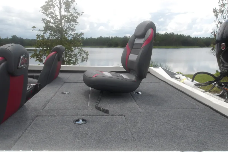 Slide: The Image of 2027 Ranger RT198P boat interior with cushioned seats by a serene lake. - 10