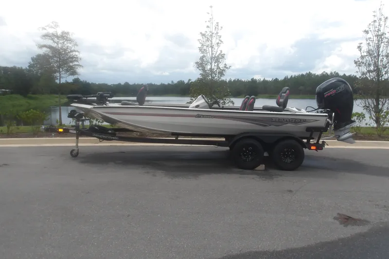The Image of 2027 Ranger RT198P boat on trailer by a scenic lake. - 1