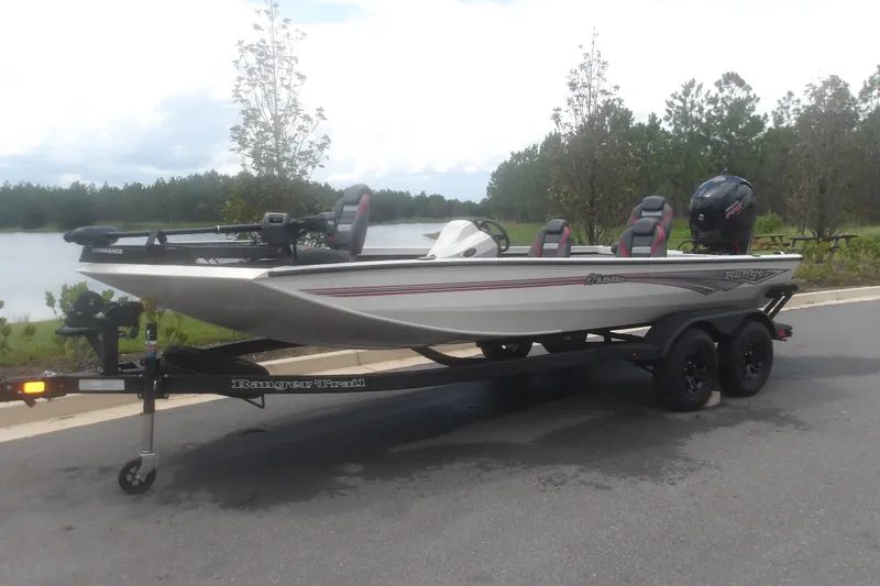 Slide: The Image of 2027 Ranger RT198P fishing boat on trailer by a lake. - 2